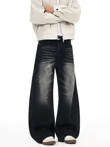 Men's wide leg distressed denim pants in washed grey with pleated scratch details