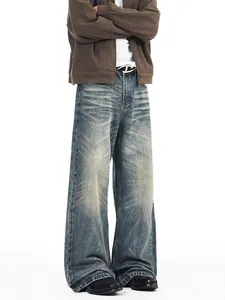 Oversized American vintage washed denim jeans with distressed whiskers and wide-leg fit