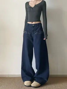Loose straight dark blue jeans with silver star rivets and relaxed retro aesthetic