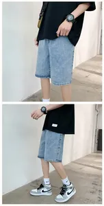 Detail view of light blue straight denim shorts for men showing the loose fit and washed fabric