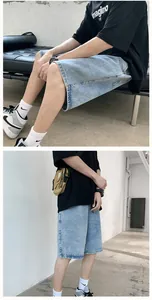 Detailed view of men's loose light blue denim shorts with vintage washed texture