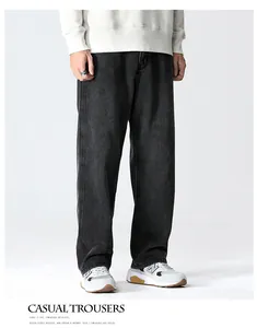 Detail of loose fit washed black denim jeans with high-quality soft stretch fabric texture