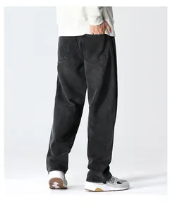 Detailed back view of relaxed straight leg washed denim jeans with vintage faded texture