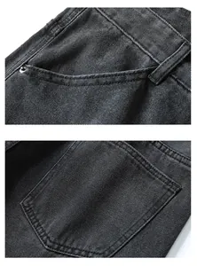 Detailed macro view of dark grey denim texture with metal rivets and reinforced stitching