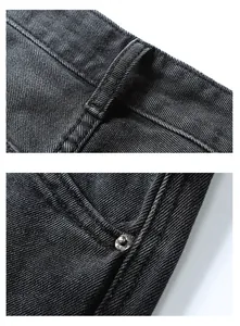 Detail of waist loops and metal rivets on loose fit black denim jeans for men