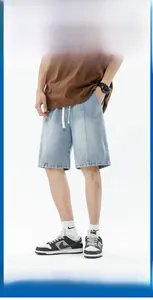 Detail view of light blue gradient denim shorts with vertical stitching and white drawstring