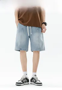 Detail of light blue denim shorts featuring a drawstring waist and vertical seams