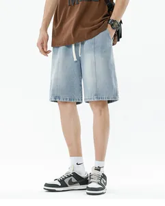 Detailed view of light blue denim shorts with vintage wash and white drawstring waist