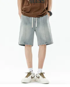 Front view of men's loose light blue denim shorts with drawstring waist and washed finish