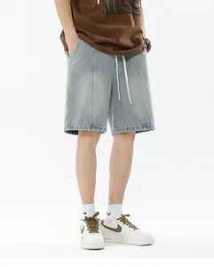 Close-up of men's light blue gradient denim shorts with white drawstring and topstitch details