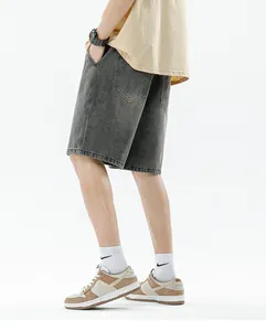Detail of vintage gradient washed grey denim shorts featuring loose fit and retro texture