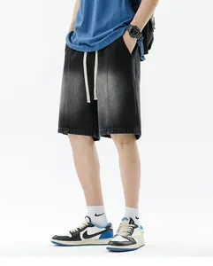 Detail view of men's gradient washed denim shorts with cream drawstring and streetwear fit