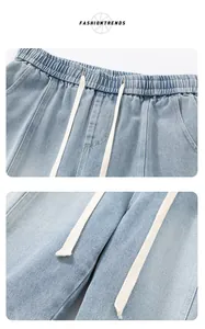 Detail of light blue denim shorts featuring an elastic drawstring waist and premium fabric