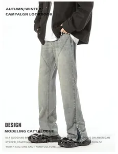 Detail view of washed blue flared jeans featuring side split zippers and paneling seams