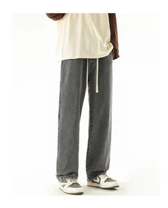Close-up of vintage grey wide-leg jeans featuring a white drawstring and elastic waist