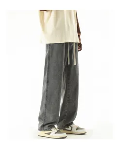 Detail view of dark grey washed wide-leg denim jeans with adjustable drawstring waist