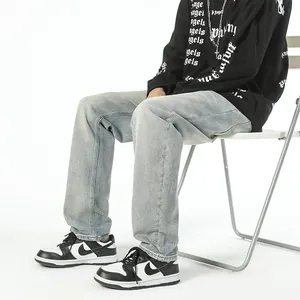 Light blue vintage tapered jeans for men with embroidery detail in a streetwear style