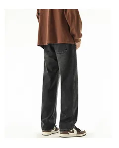 Detail view of baggy washed black denim jeans with retro wide leg fit and back pockets