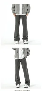Detail view of washed grey jeans featuring leg zippers and decorative v-stitch seams