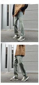 Detailed close-up showing light blue-green washed denim texture and straight fit on a model