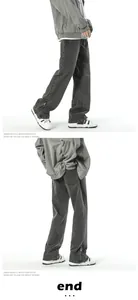 Detail view of washed grey jeans showing side leg zippers and straight-leg fit design