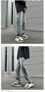 Detail of light blue washed denim jeans showing retro texture and straight fit on street