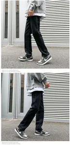 Close-up of black straight-leg jeans in an American retro street style urban setting