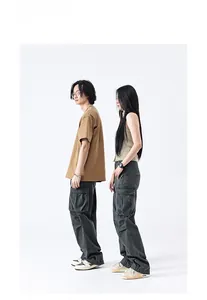 Detail showing deep grey cargo pants with side flap pockets and wide leg street style