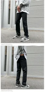 Detail view of black straight-leg men's retro streetwear jeans with durable denim fabric