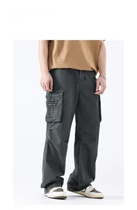 Detail view of washed grey cargo pants with side bellows pockets and metal zipper accents