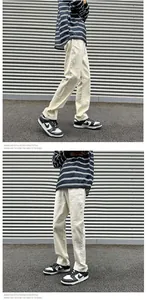 Close-up of straight-leg stretch denim trousers in off-white for a retro street look
