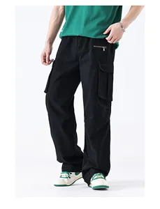 Detail of classic black cargo pants with large flap pockets and decorative metal zipper