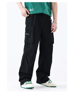 Detail view of black cargo pants with multiple utility pockets and zip decorations