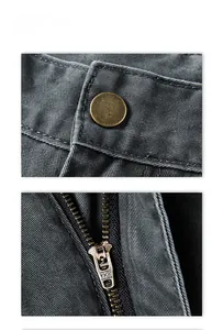 Macro detail of high-quality YKK metal zipper and vintage bronze button on cargo pants