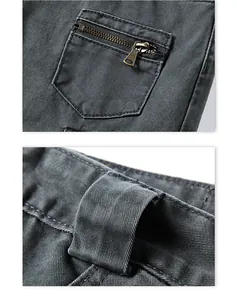 Detail view of dark grey cargo pants featuring vintage metal zippers and sturdy belt loops