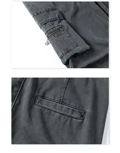 Detail of charcoal grey cargo pants showing multi-pocket design and metal zipper closure