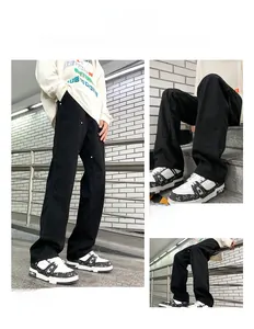 Detail view of black double knee work pants with rivet accents and multi-pocket design