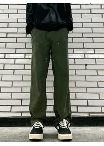 Detail shot of olive green double knee work pants with metal rivets and a straight cut
