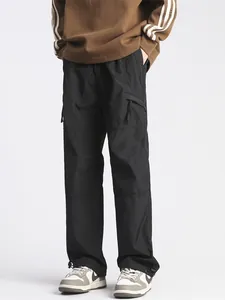 Men's loose black cargo pants with utility pockets and adjustable drawstring cuffs