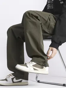 Men's dark olive green techwear cargo pants with straight leg and drawstring cuffs