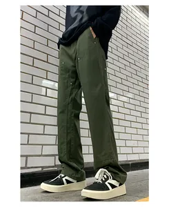 Close-up of military green double knee work pants with reinforced rivets and stitching
