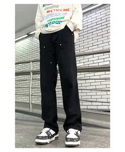 Detail shot of black double knee work pants with silver metal rivets and baggy fit