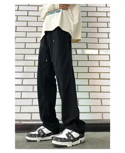 Detail of men's wide-leg carpenter pants with rivet hardware and paneling construction