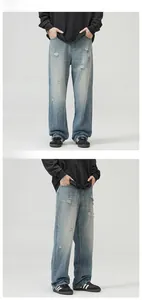 Macro detail of men's loose light blue ripped denim with vintage washed streetstyle texture