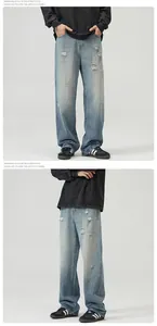 Detail view of American style washed blue distressed jeans with ripped denim texture