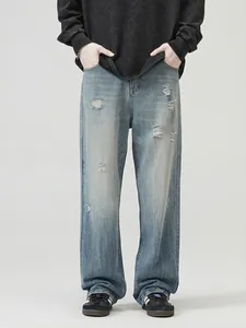 Men's loose straight-leg jeans in vintage light blue with distressed ripped details