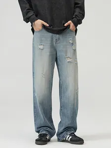 Men's loose fit distressed light blue washed jeans with stylish ripped knee details