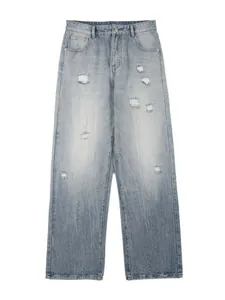 Men's light blue distressed wide-leg jeans with washed denim and vintage ripped details