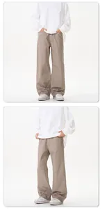 Detail view of khaki cotton twill wide-leg trousers in high-waisted straight cut style