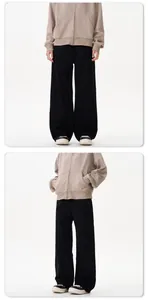 Front and side view of black wide-leg trousers paired with a beige zip-up hoodie